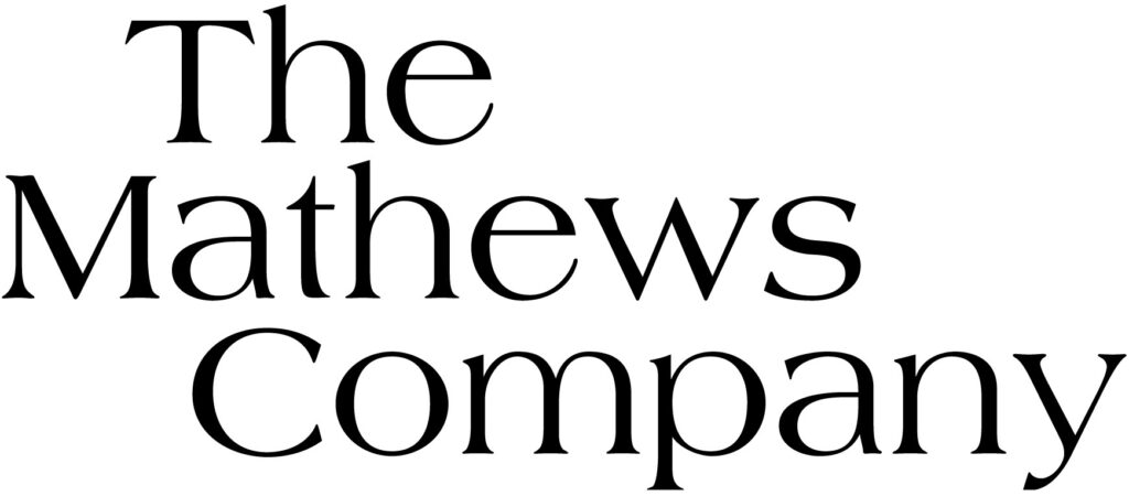 Elegant black text on a white background reading "the mathews company" in a serif font, likely representing a business or corporate entity named after a person or family with the surname mathews.