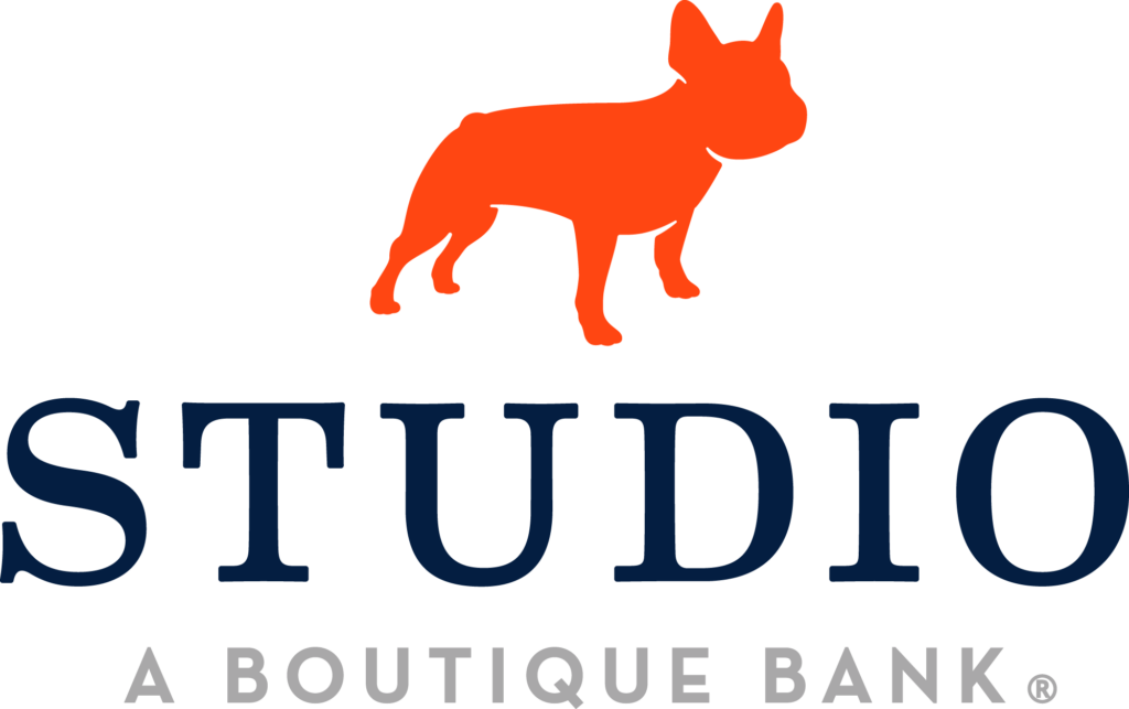 The image shows a logo that includes a stylized depiction of a dog alongside the word "studio" in large, bold letters, with "a boutique bank" written underneath in a smaller font, indicating the brand or company name along with its descriptor.