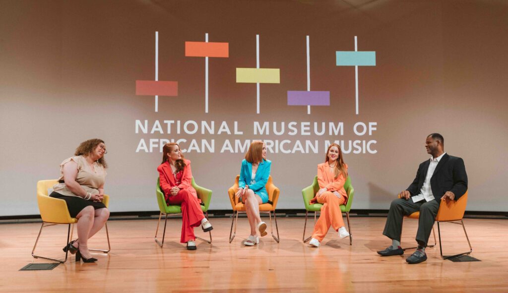 Panel discussion at the national museum of african american music with speakers engaged in a meaningful conversation.