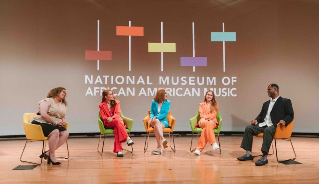 Panel discussion at the national museum of african american music with speakers engaged in a meaningful conversation.