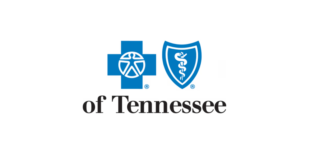 Logo of bluecross blueshield of tennessee, featuring a blue cross with a geometric pattern and a blue shield containing a medical caduceus symbol, indicating healthcare services.