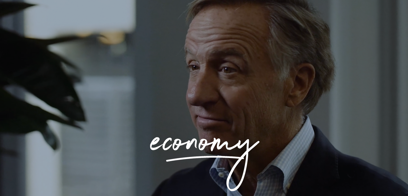 A thoughtful man in a business setting with the word "economy" inscribed across the image, suggesting a focus on financial or economic topics.